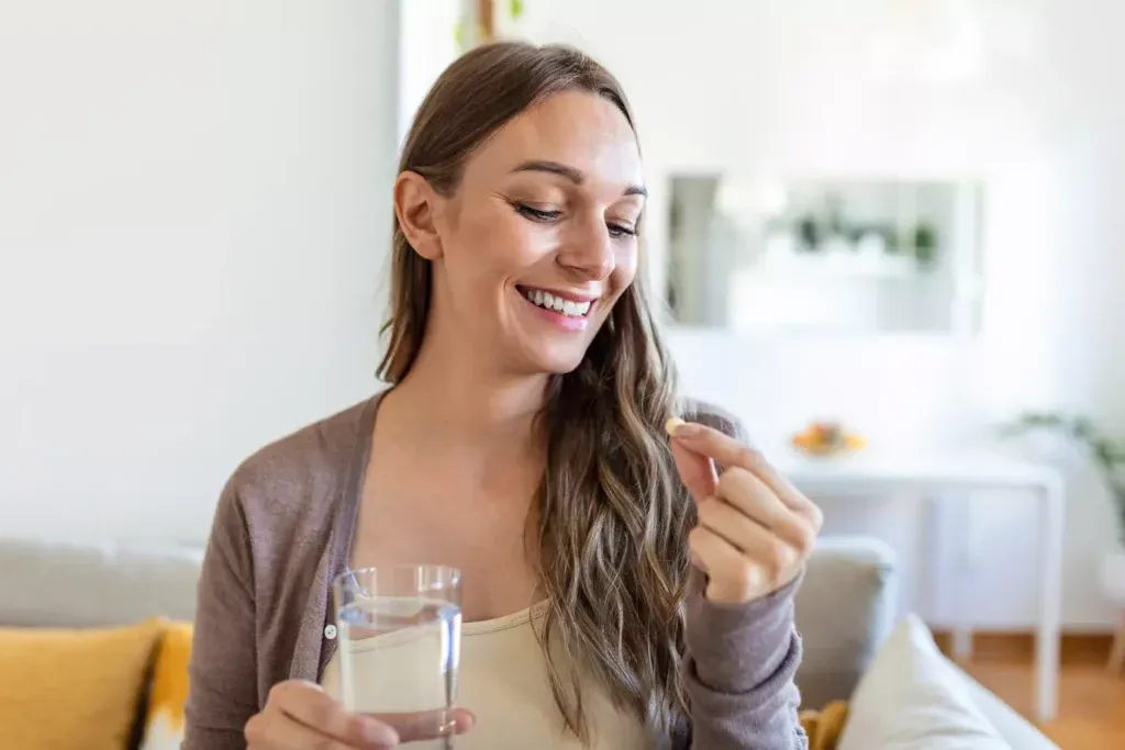 Woman taking oral HRT medication